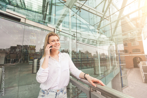 Young woman talking on mobile phone with a glazed background