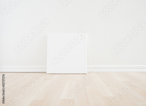 Fototapeta Naklejka Na Ścianę i Meble -  Empty room interior with blank canvas on floor