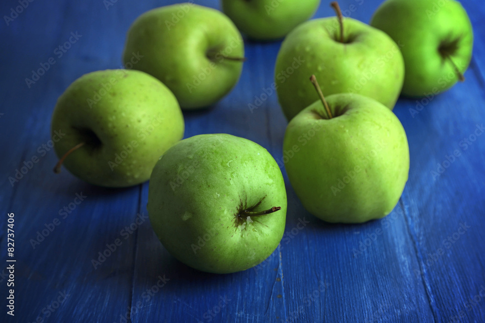 Green apples on color wooden background Green apples on color wooden background