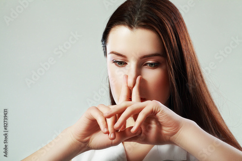Canvas-taulu woman pinches nose