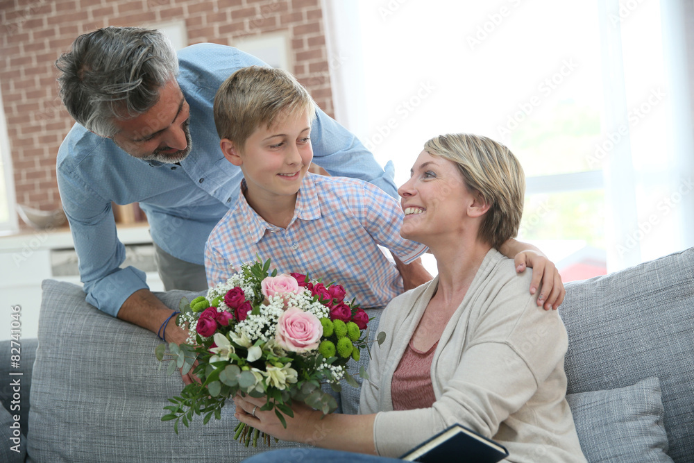 Young boy giving flowers to mommy for mother's day Young boy giving flowers to mommy for mother's day