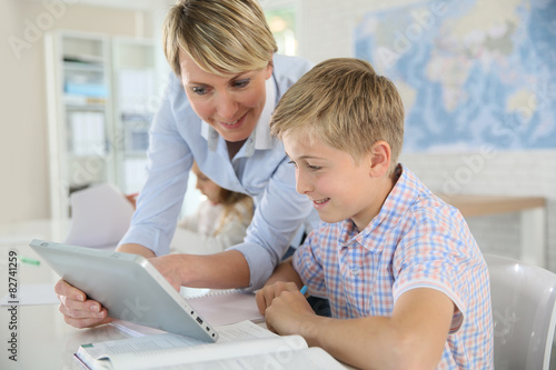 Teacher using digital tablet as educational tool in class