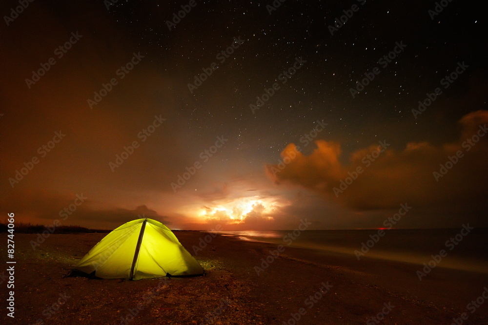 touristic tent on the beach by night - long exposure image