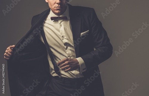 Sharp dressed fashionist wearing jacket and bow tie photo