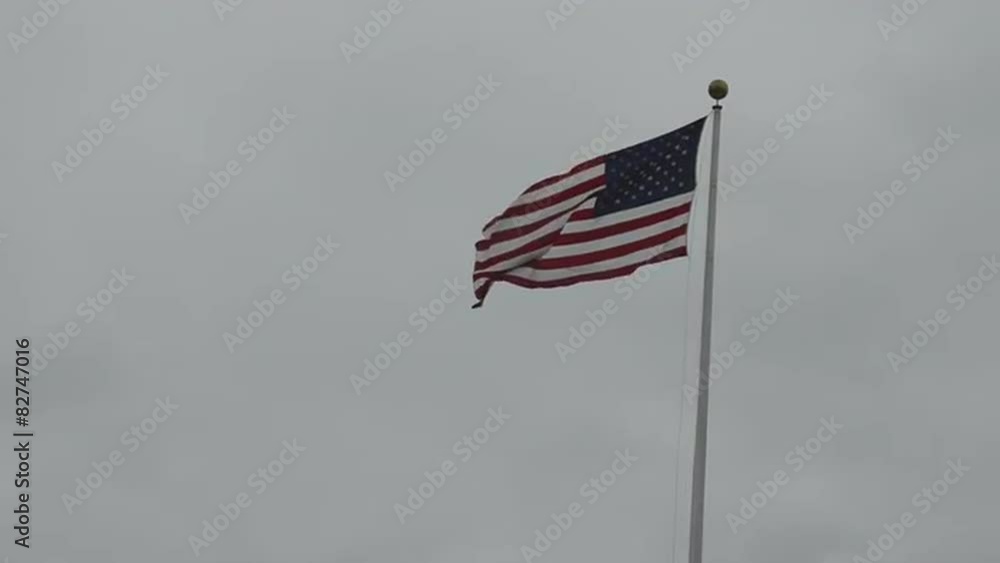 American flag waves on a cloudy and overcast day American flag waves on a cloudy and overcast day