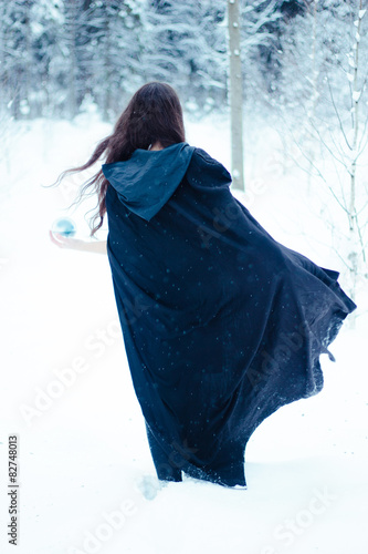Obraz na plátně Witch in black cloak with magiс ball