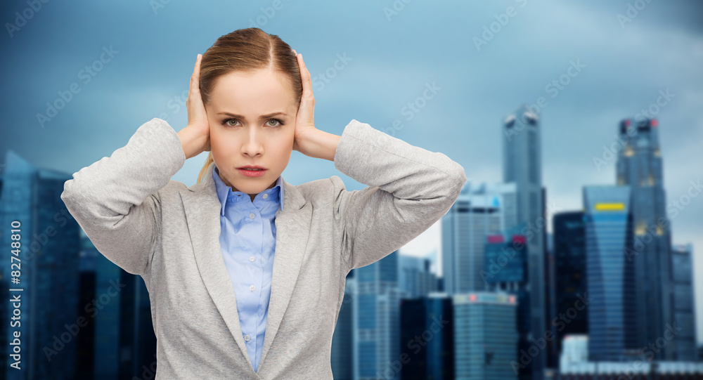 stressed businesswoman with covered ears stressed businesswoman with covered ears