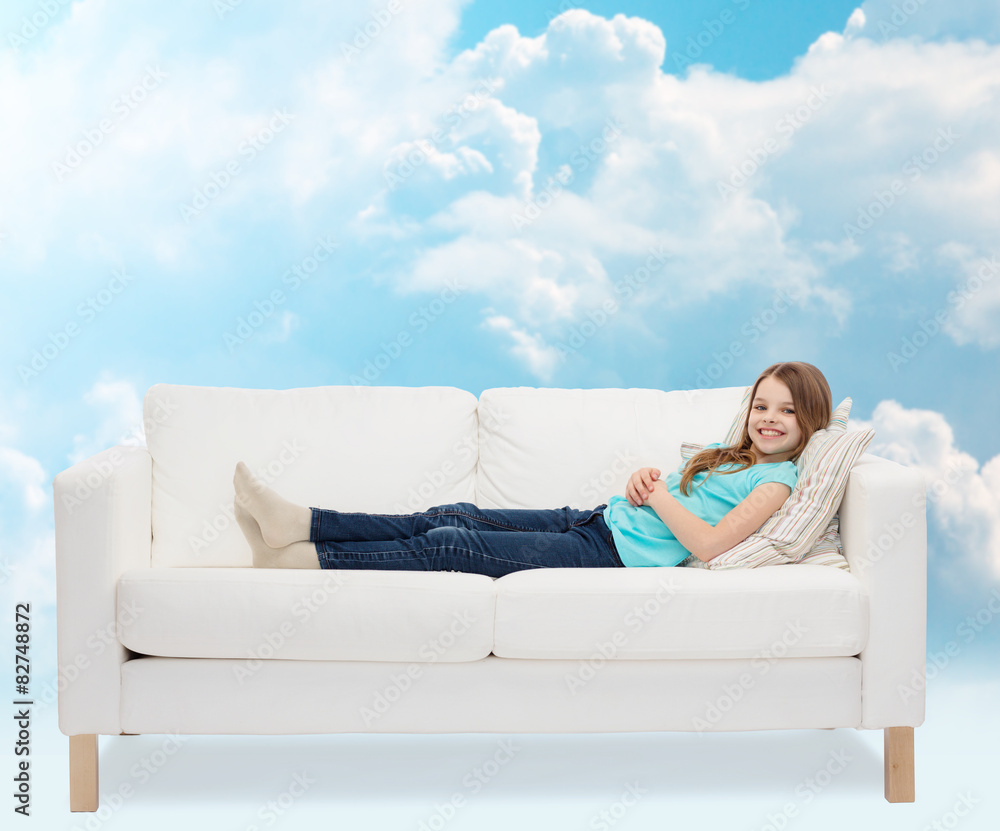 smiling little girl lying on sofa smiling little girl lying on sofa