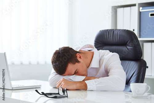 Young businessman in white shirt sleeping