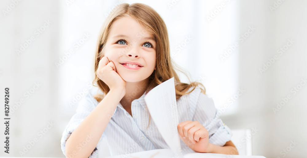 little student girl studying at school little student girl studying at school