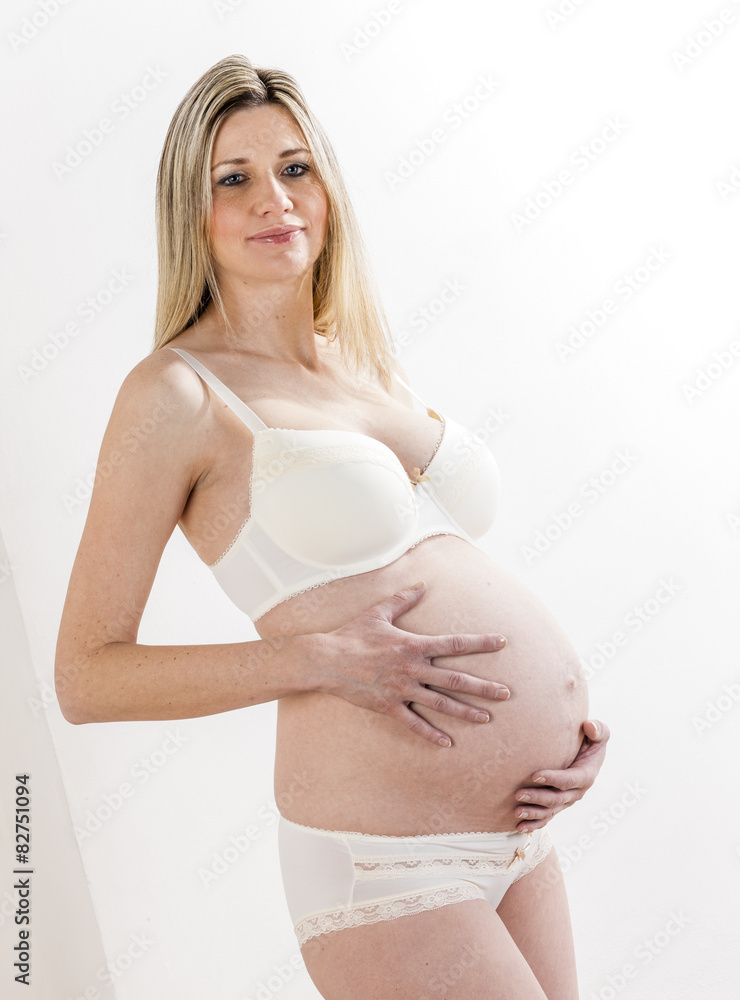 portrait of standing pregnant woman wearing lingerie portrait of standing pregnant woman wearing lingerie