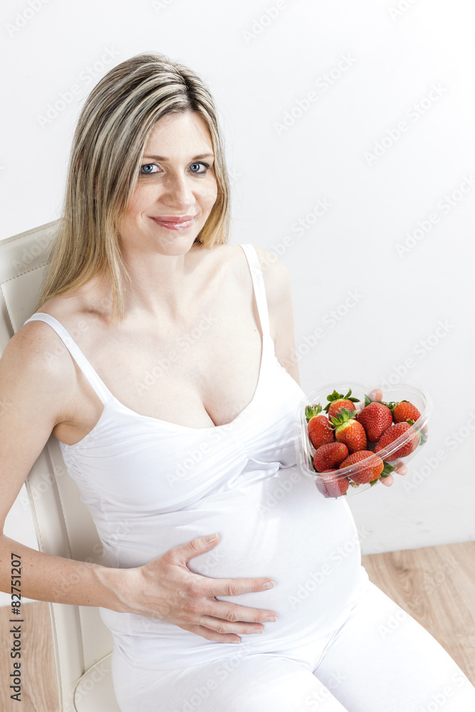 portrait of pregnant woman with strawberries portrait of pregnant woman with strawberries