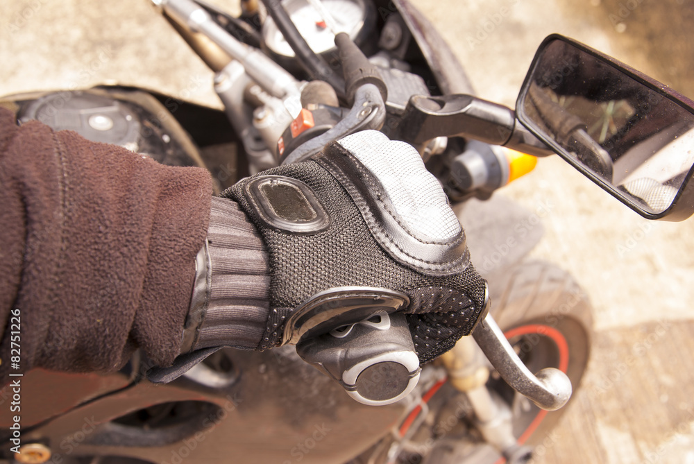 Biker hand rests on the steering wheel motorcycle Biker hand rests on the steering wheel motorcycle
