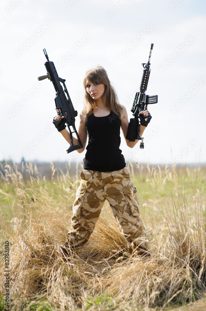 Fototapeta premium Beautiful army girl with guns