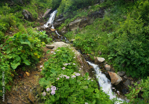 Waterfall in summer canyon. Natural landscape