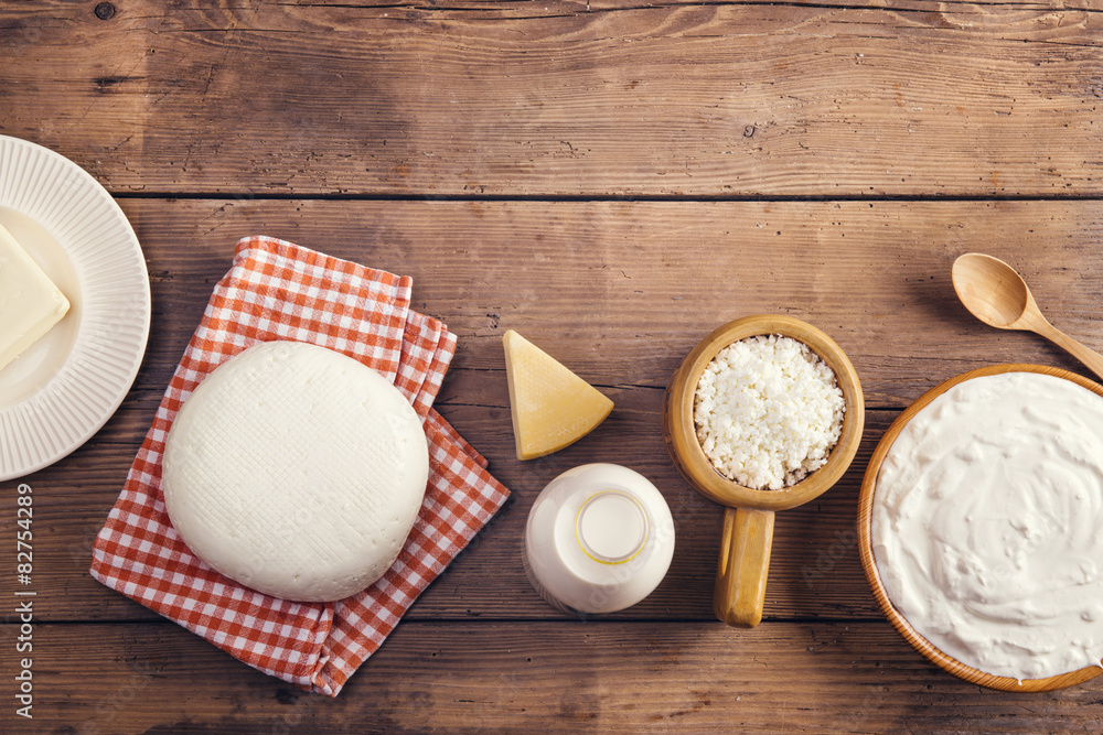 Variety of dairy products laid on a wooden table background Variety of dairy products laid on a wooden table background