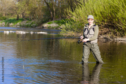 woman fishing in the river in spring