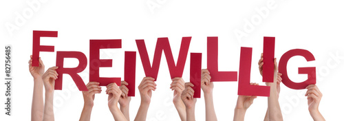 People Holding Red Word Freiwillig Means Voluntary