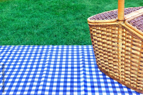 Picnic Basket On The Table With Blue White Tablecloth
