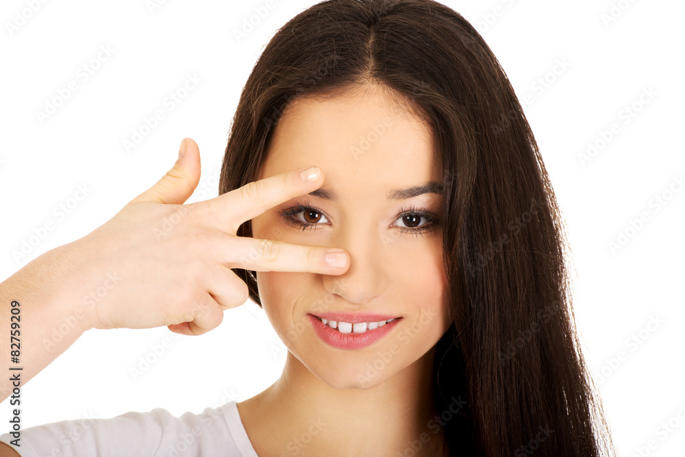 Young woman showing victory sign. Young woman showing victory sign.