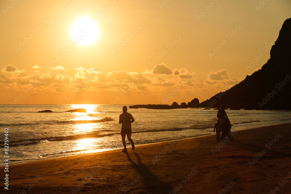 Silhouette of a fit runner at sunset