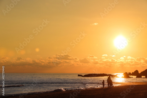 Beach landscape with silhouette of mother with children © zlikovec