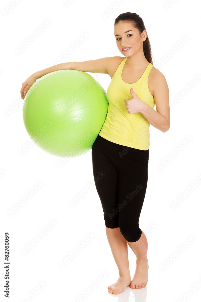 Young woman with pilates ball. Young woman with pilates ball.