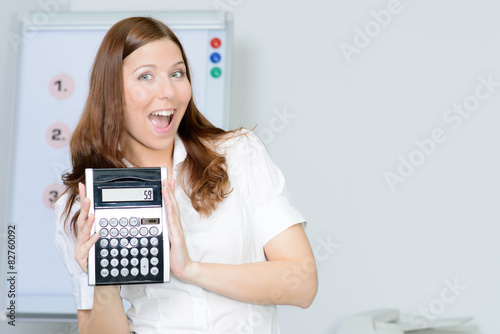 beautiful businesswoman pointing to the calculator