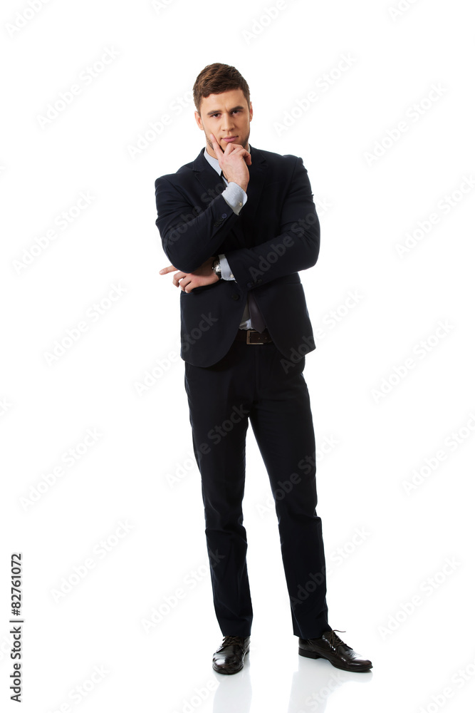 Successful businessman with finger under chin. Successful businessman with finger under chin.