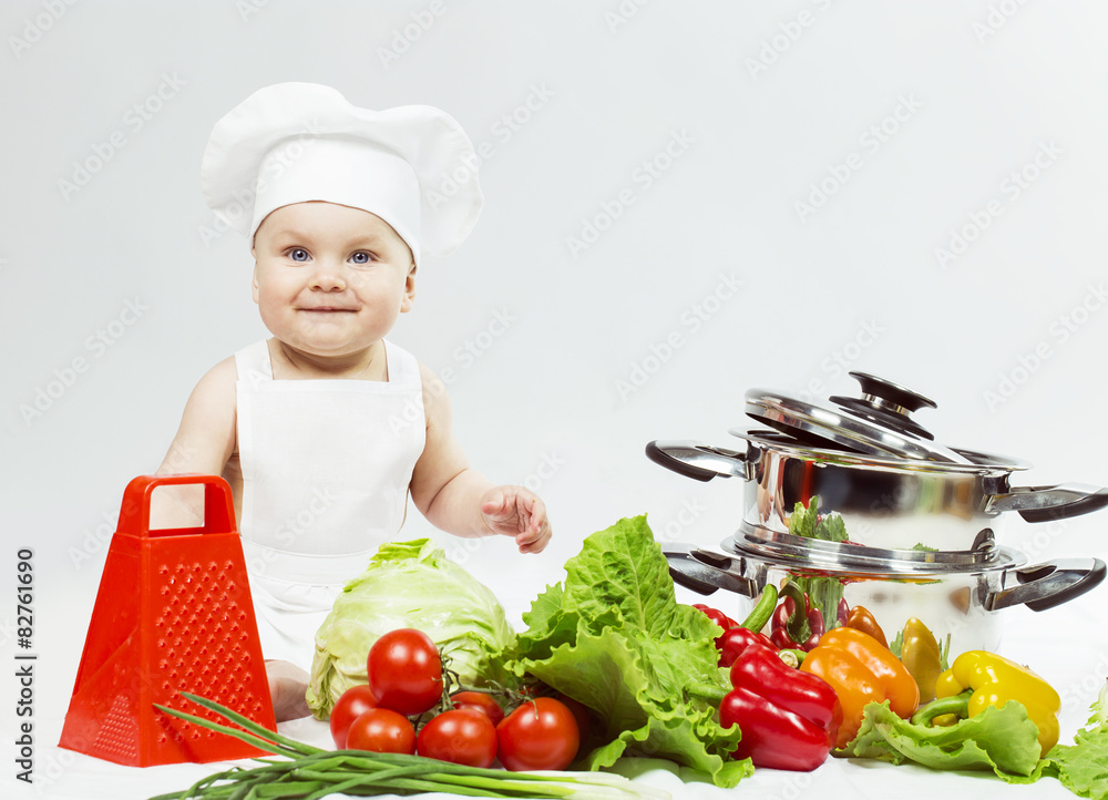 Little Chef boy preparing healthy food and looking and smiling i Little Chef boy preparing healthy food and looking and smiling i