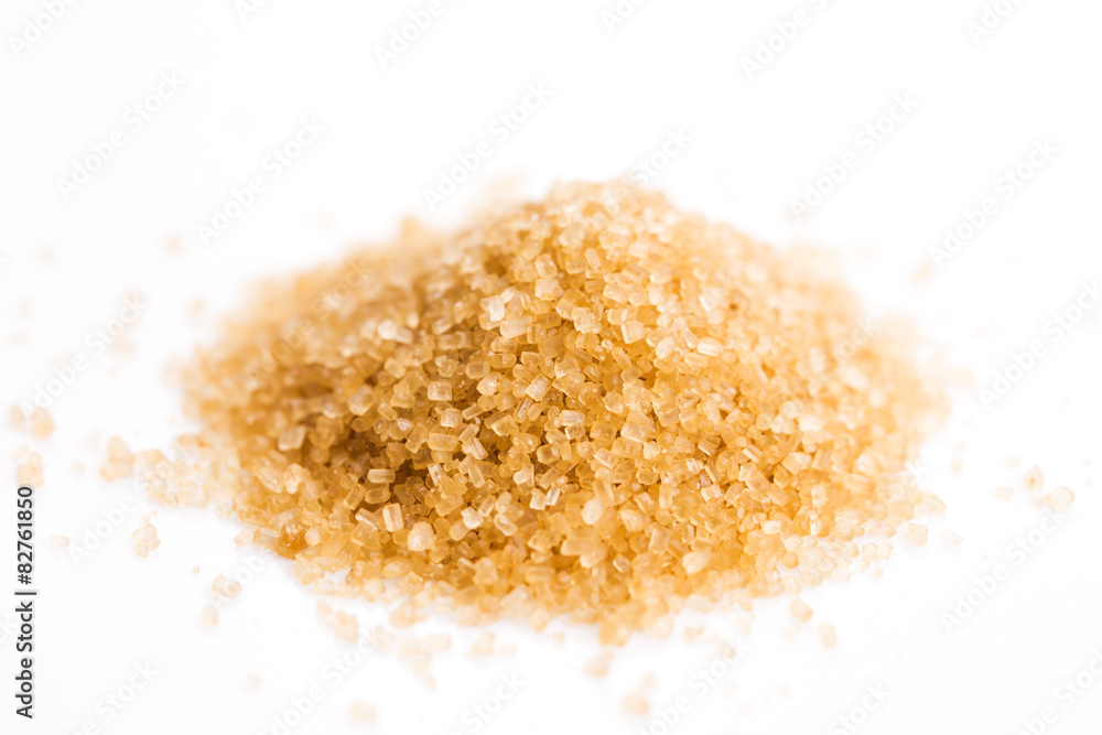 Crystals cane sugar heap close up isolated on white Crystals cane sugar heap close up isolated on white