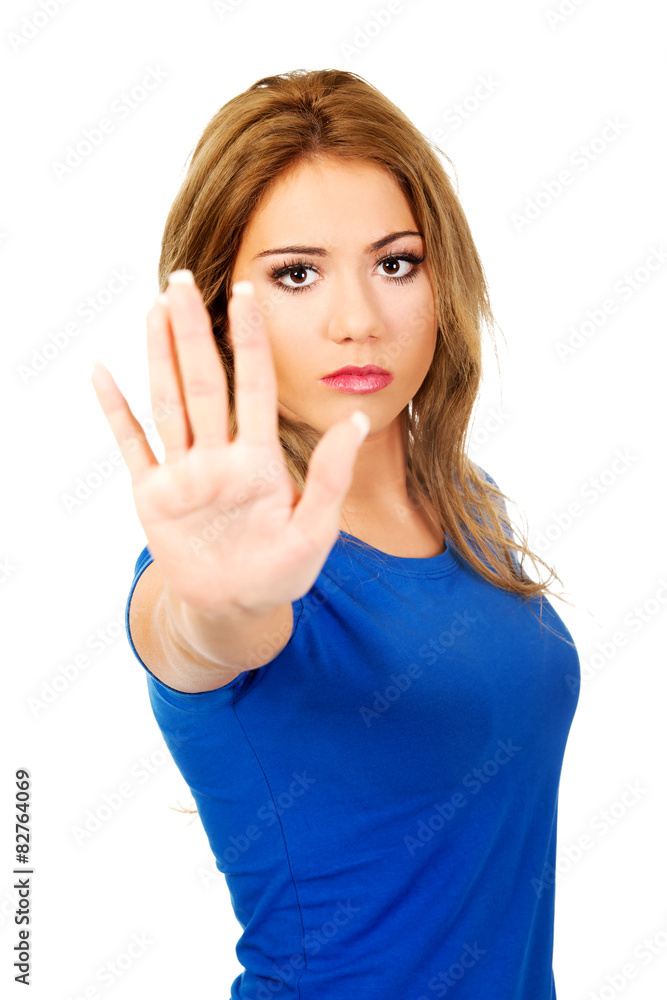 Young woman making stop sign. Young woman making stop sign.