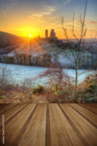 Castle in landscape Winter sunrise with wooden planks floor © veneratio