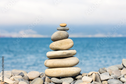 Stone pyramide on pebble shore