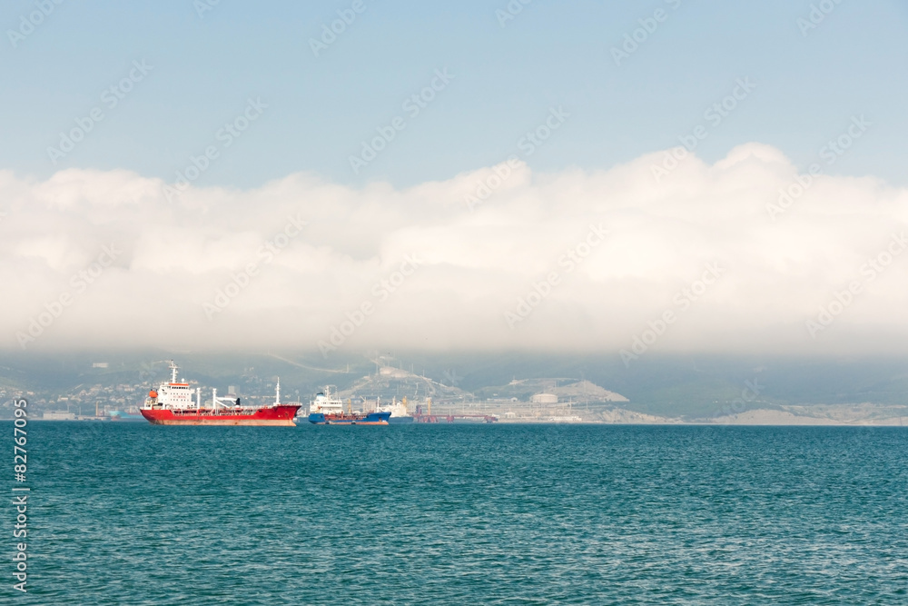 Red ship at anchor in ports water Red ship at anchor in ports water