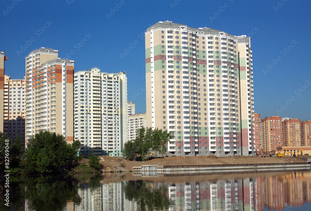 Constructed buildings in city district after river and clear sky Constructed buildings in city district after river and clear sky