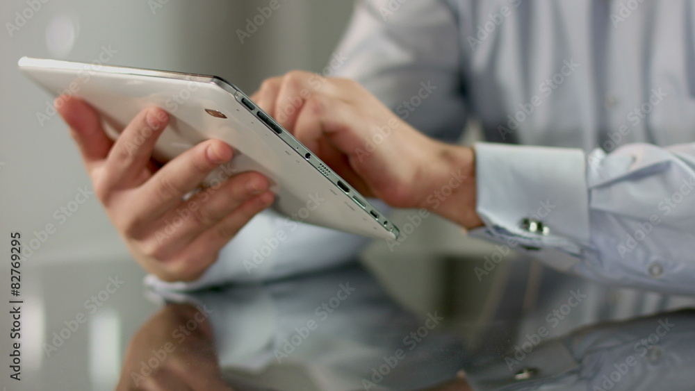 Man working on tablet PC, responding e-mail, typing message text Man working on tablet PC, responding e-mail, typing message text