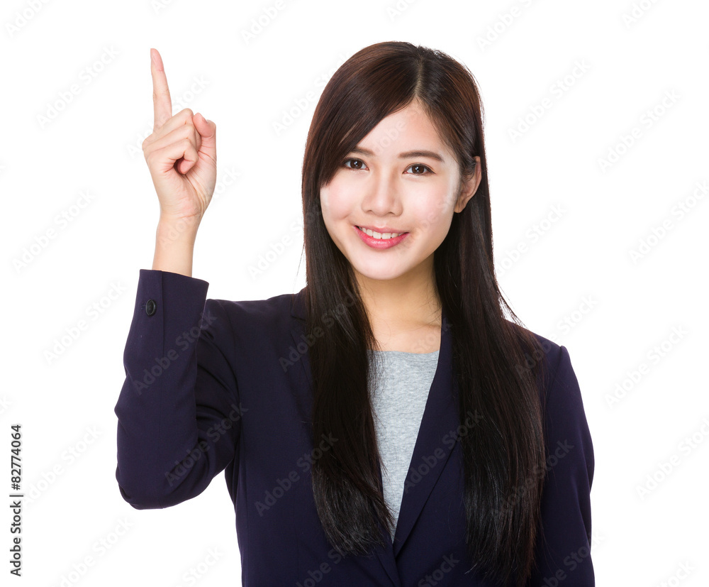 Businesswoman with finger showing upwards Businesswoman with finger showing upwards