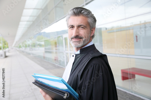 Portrait of lawyer standing outside courthouse building