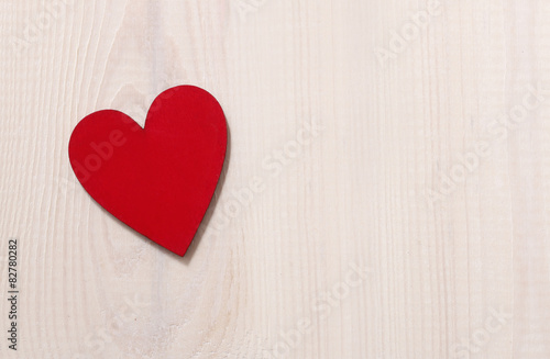 Red hearts on wooden background.