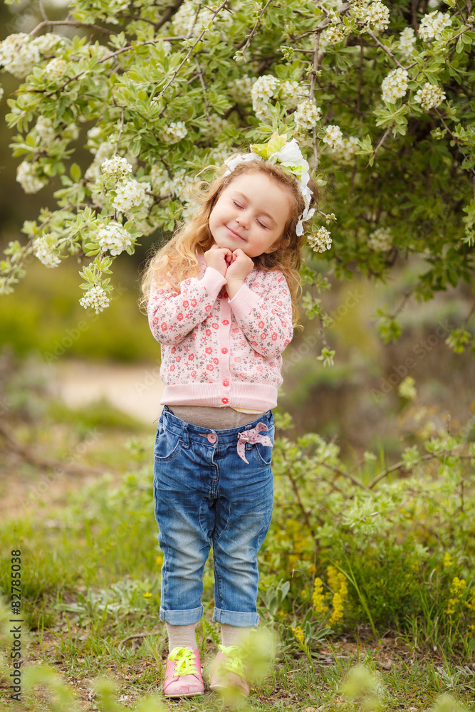 Portrait of little girl outdoors in a lush garden. Portrait of little girl outdoors in a lush garden.