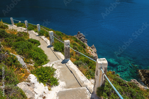 Typical Greek white stairs leading to divers bay on Greek coast