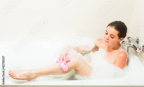 Girl in foam at bathtub