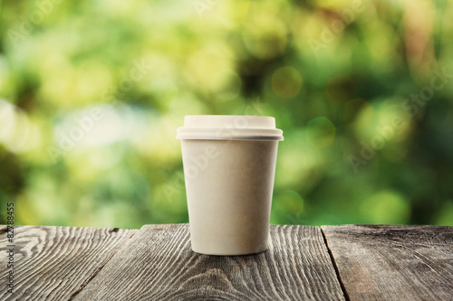 paper cup of coffee on natural background