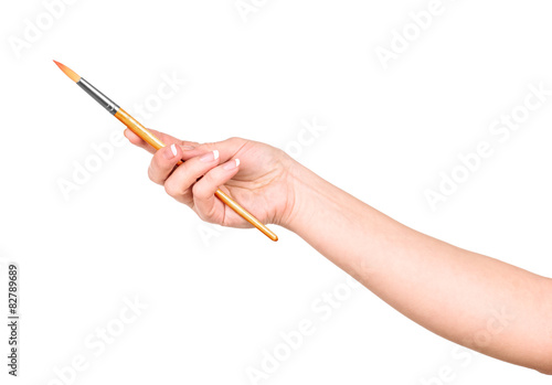 hand draws a brush on an isolated white background