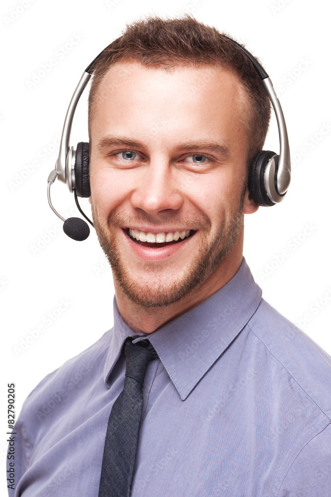 Handsome smiling young businessman using headset Handsome smiling young businessman using headset