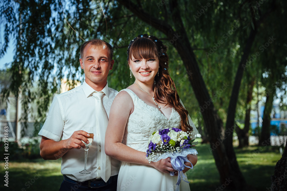 Fototapeta premium wedding couple kissing in green summer park. bride and groom