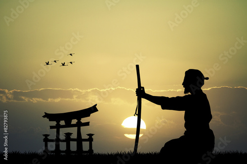 Fotografie Japanese man with sword at sunset