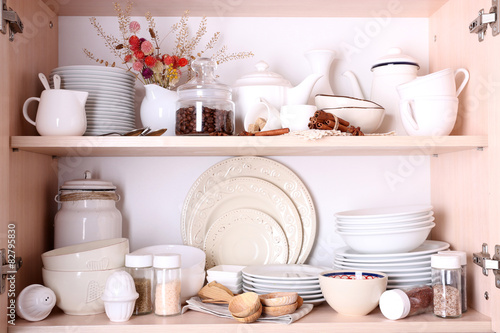 Kitchen utensils and tableware on shelves