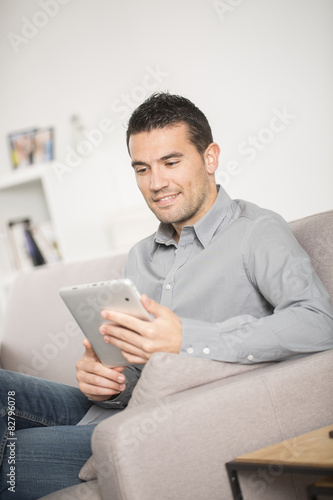 Man using tablet pc at home